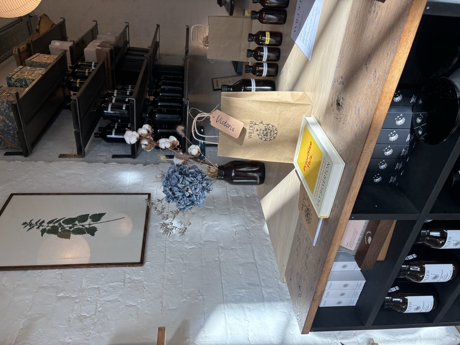 Prioritise This by Lily Silverton on the counter at Wilder Botanics, beside a named gift bag